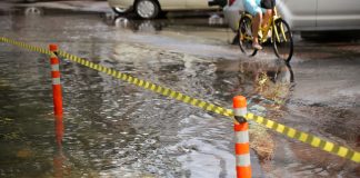 Passenger Switches Roles With Elderly Pedicab Driver Amid Flood